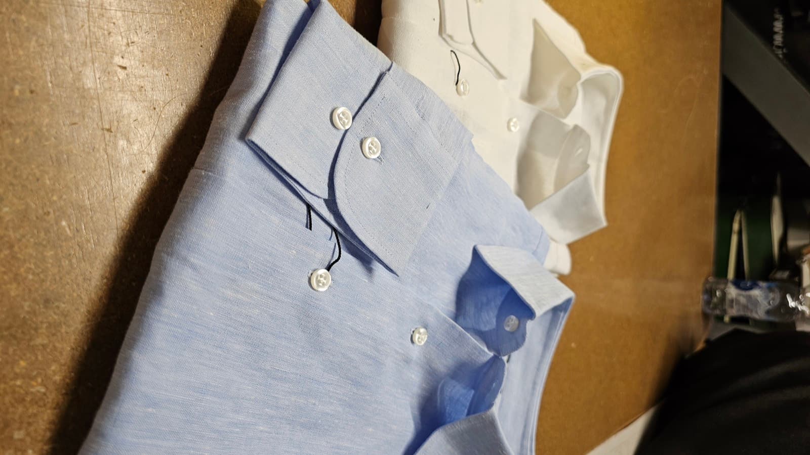 White and pale blue linen shirts, folded
